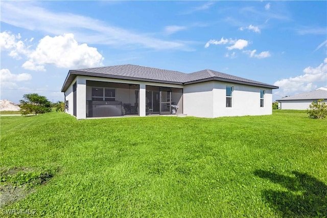 rear view of property with a sunroom and a lawn