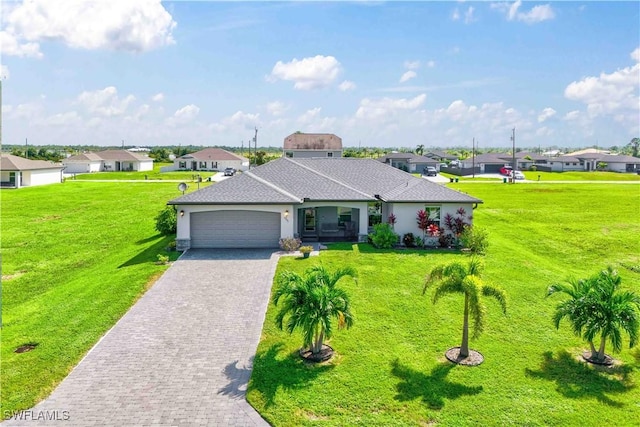 ranch-style home featuring a garage and a front lawn