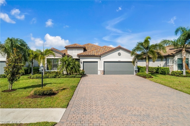 mediterranean / spanish house with a front lawn and a garage