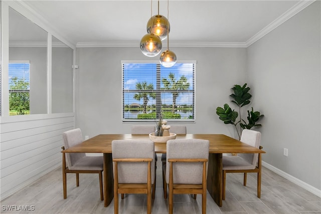 dining room featuring baseboards and crown molding