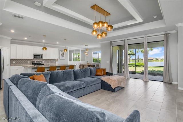 living room with a notable chandelier, crown molding, light tile patterned floors, and a raised ceiling