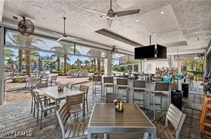 dining area featuring a wall of windows and ceiling fan