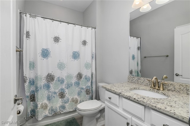 full bath with a shower with shower curtain, vanity, and toilet