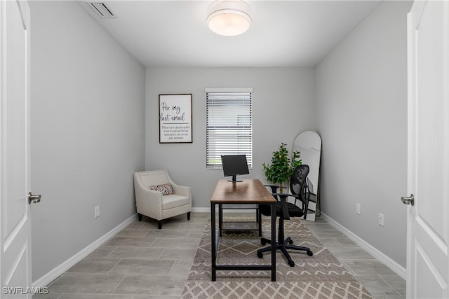 office space featuring wood tiled floor, visible vents, and baseboards