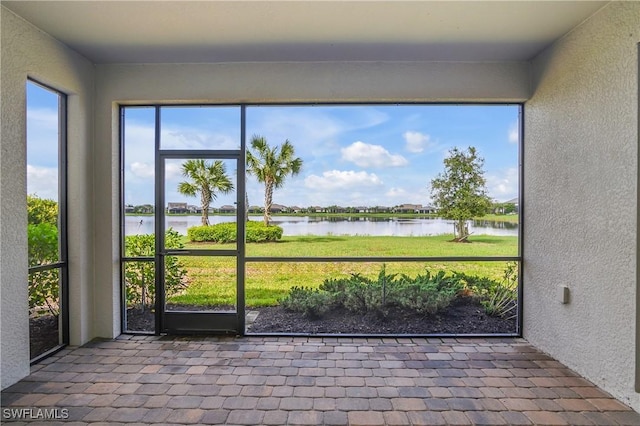 19644 The Place Blvd, Estero, FL 33928 - unfurnished sunroom with a water view and a textured wall