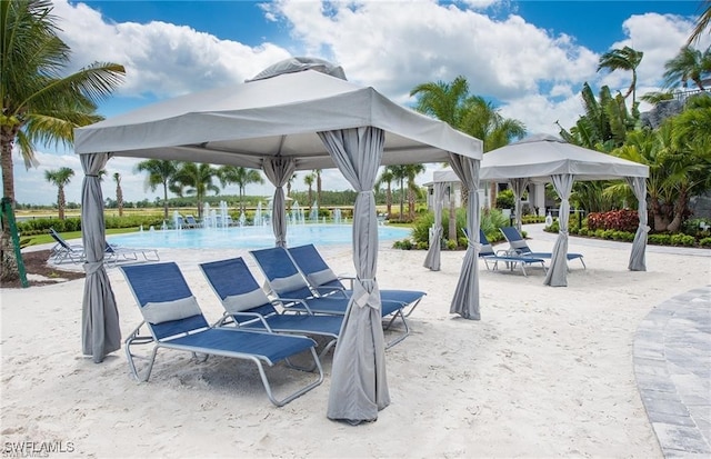 view of patio / terrace with a community pool and a gazebo