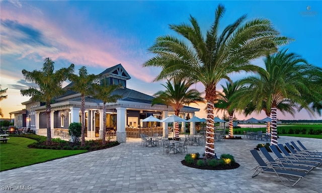 view of community with a patio and a lawn