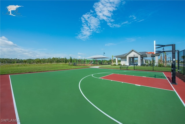 view of basketball court featuring community basketball court, fence, and a yard