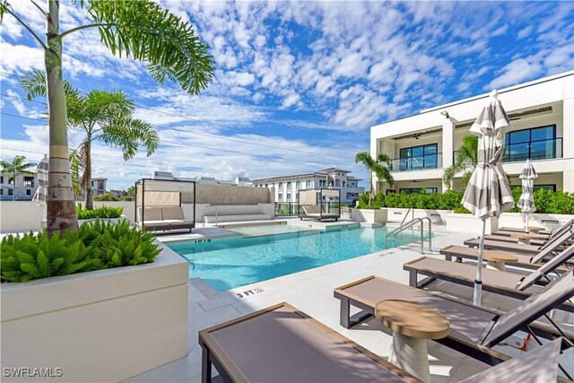 view of pool featuring outdoor lounge area and a patio