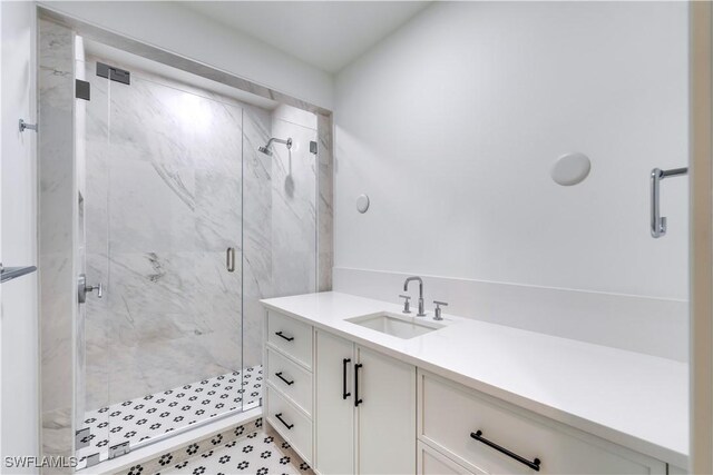 bathroom with a shower with door and vanity