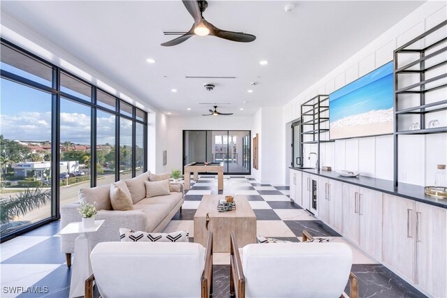 living room featuring a healthy amount of sunlight and ceiling fan