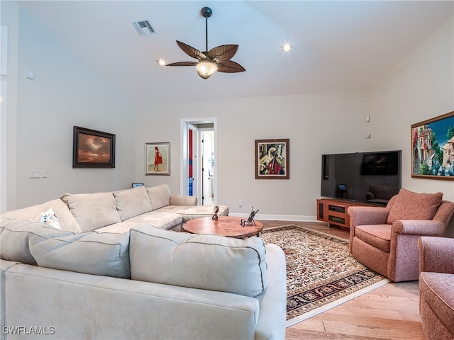 living room with light hardwood / wood-style flooring, lofted ceiling, and ceiling fan