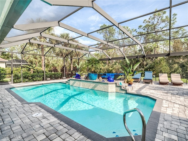 view of pool featuring a patio and glass enclosure