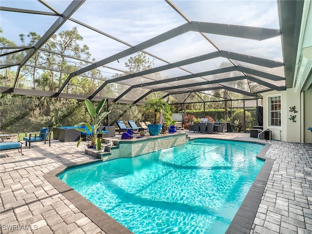 view of swimming pool with a hot tub, a patio area, and glass enclosure