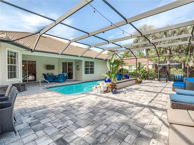 view of swimming pool featuring a patio and a lanai