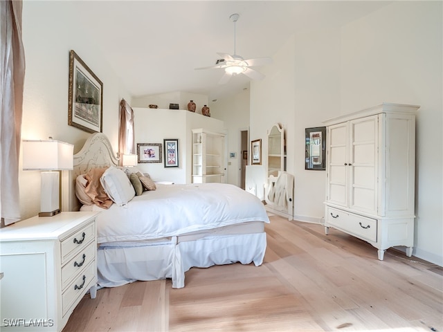 bedroom featuring high vaulted ceiling, light hardwood / wood-style floors, and ceiling fan