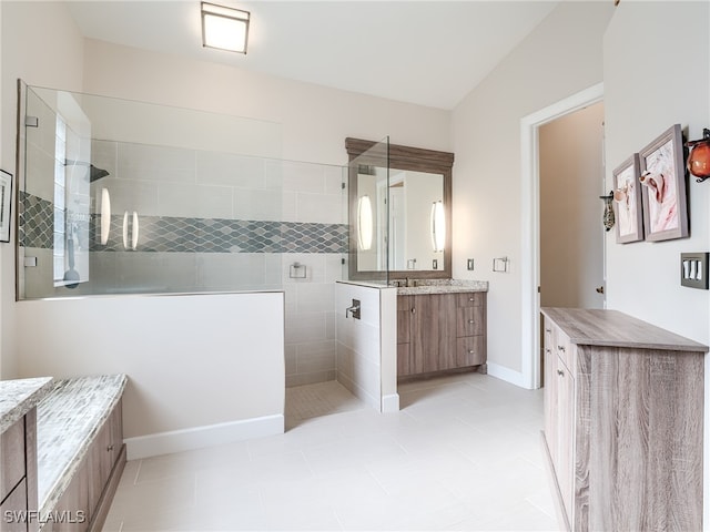 bathroom with vanity, tile patterned floors, and tiled shower