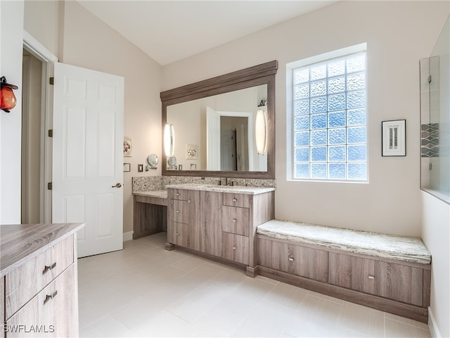 bathroom featuring vanity and vaulted ceiling