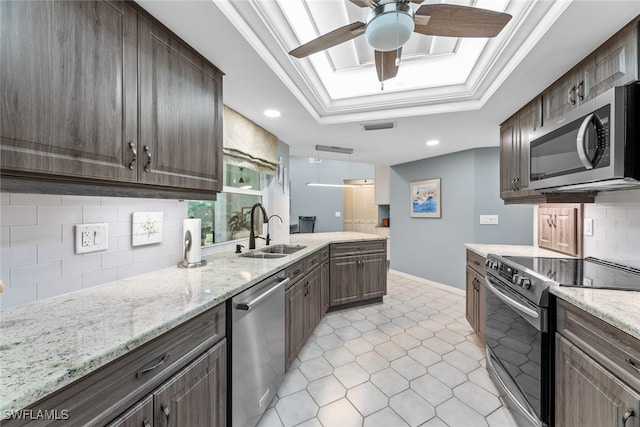 kitchen with ornamental molding, dark brown cabinetry, stainless steel appliances, and sink