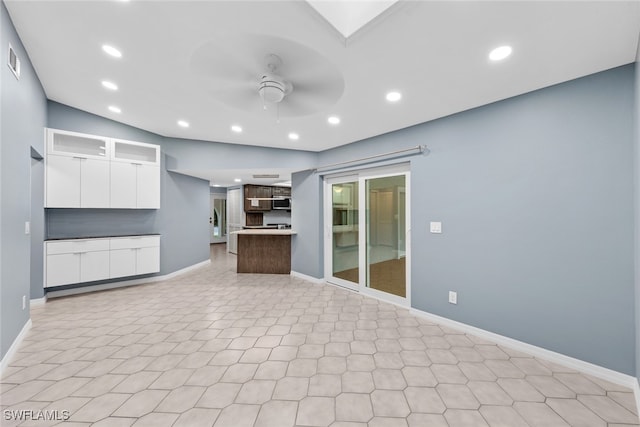 unfurnished living room with ceiling fan