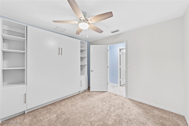 unfurnished bedroom featuring light colored carpet and ceiling fan