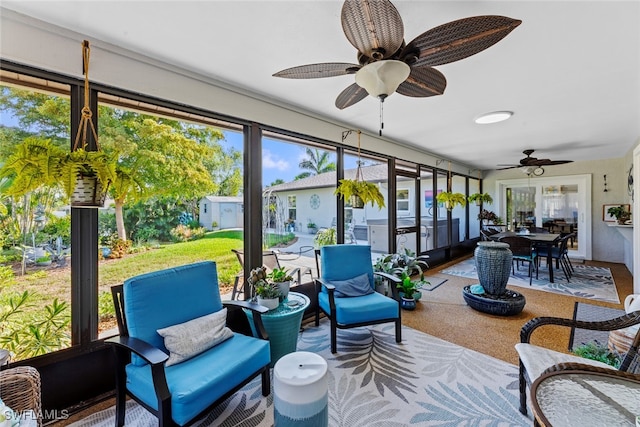 sunroom / solarium featuring ceiling fan