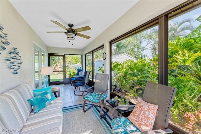 sunroom / solarium featuring ceiling fan