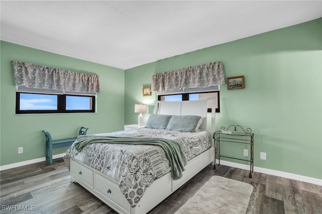 bedroom with dark wood-type flooring