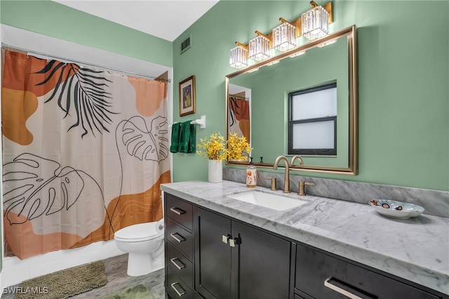 full bathroom featuring wood-type flooring, vanity, toilet, and shower / tub combo with curtain