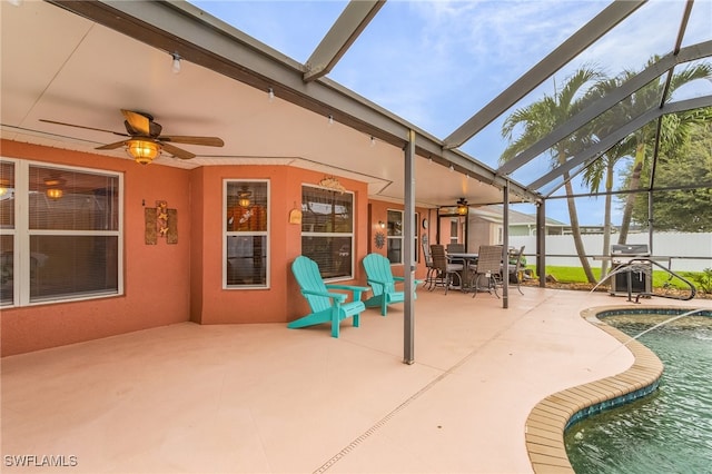 view of patio / terrace with ceiling fan, a fenced in pool, and glass enclosure