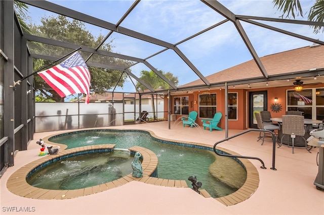 view of swimming pool featuring glass enclosure, a patio, ceiling fan, and an in ground hot tub