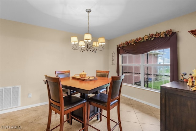 dining area featuring light tile patterned flooring and a chandelier