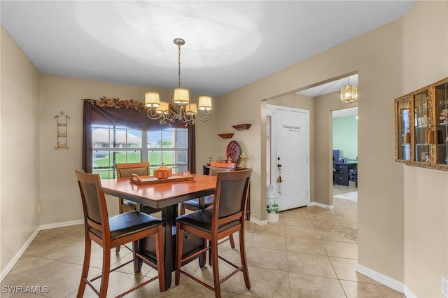 dining room with a chandelier and light tile patterned floors