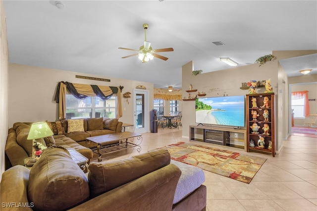 tiled living room featuring a wealth of natural light, lofted ceiling, and ceiling fan