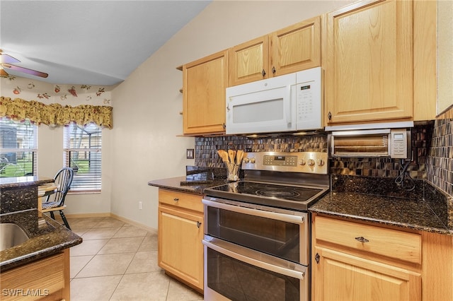 kitchen with decorative backsplash, stainless steel electric range oven, and dark stone counters