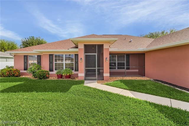 single story home with a front lawn and a sunroom