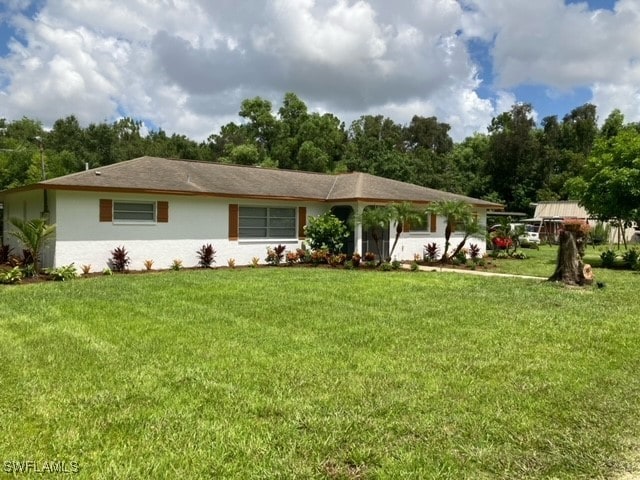 ranch-style home with a front lawn