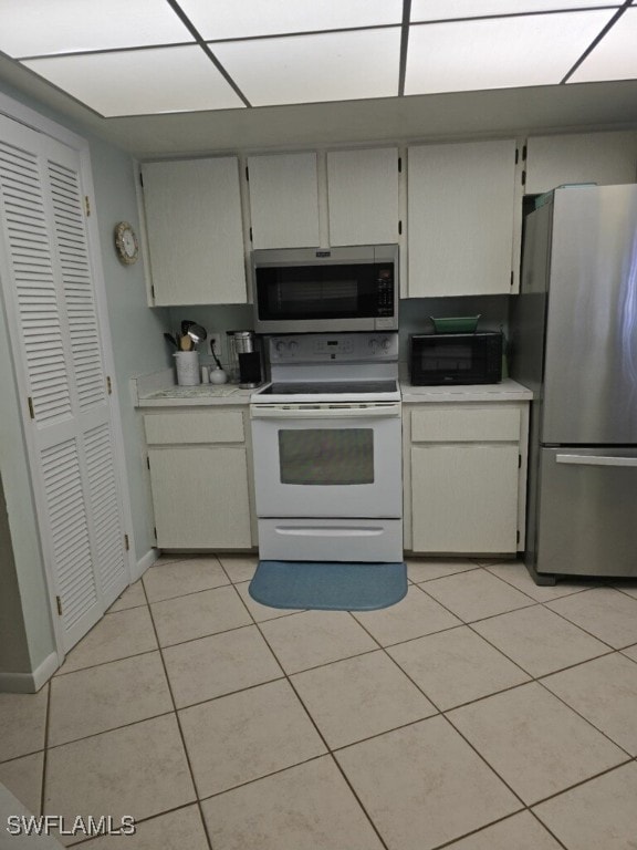 kitchen with appliances with stainless steel finishes and light tile patterned flooring