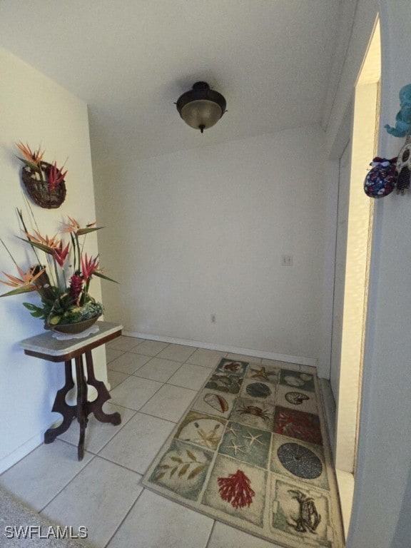 hallway with tile patterned floors