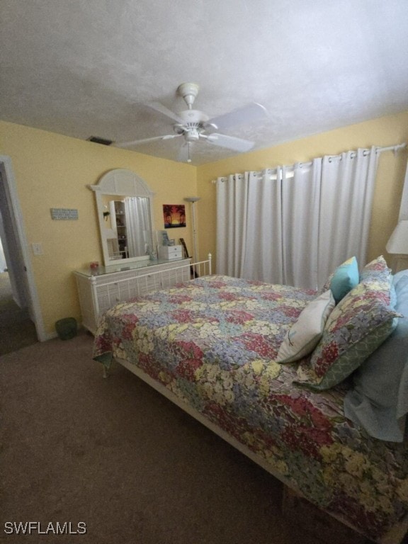 bedroom featuring ceiling fan and a textured ceiling