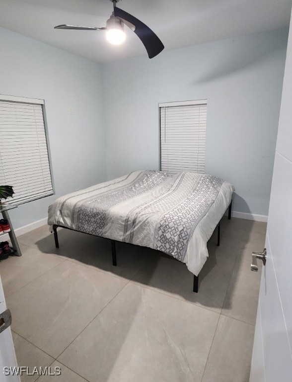 bedroom featuring light tile patterned floors and ceiling fan