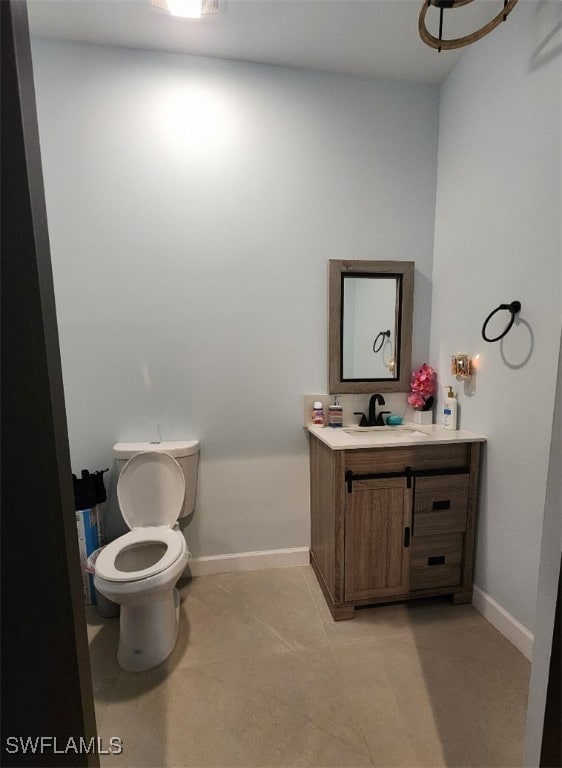 bathroom featuring vanity, toilet, and tile patterned floors