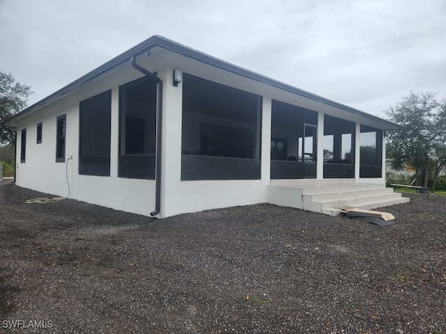 view of side of home featuring a sunroom