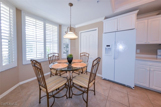 dining area featuring light tile patterned flooring and ornamental molding