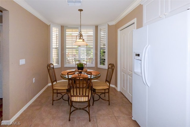 tiled dining space featuring ornamental molding