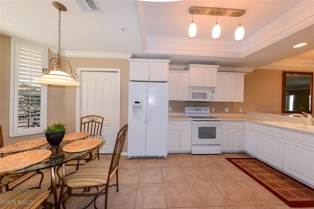 kitchen with white cabinetry, white appliances, decorative light fixtures, and a raised ceiling