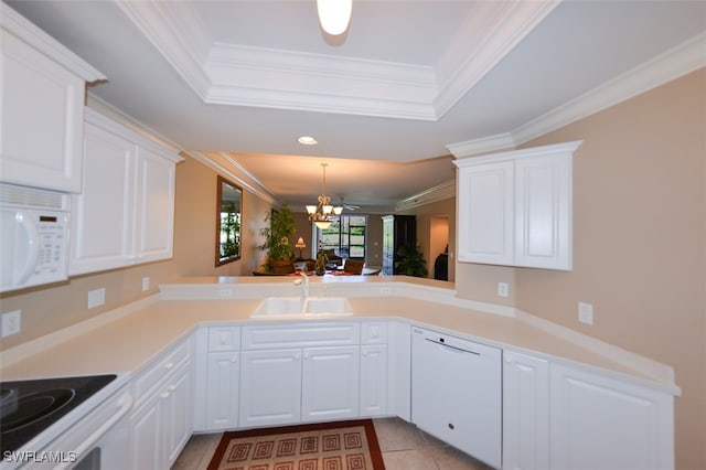 kitchen featuring white cabinetry, kitchen peninsula, a chandelier, and white appliances