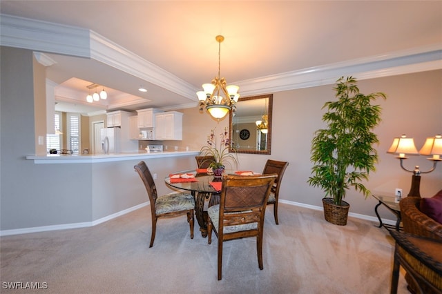 dining room featuring light colored carpet, a chandelier, and crown molding