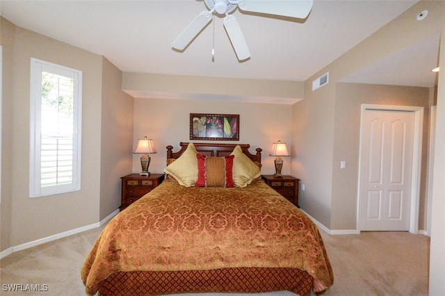 bedroom featuring ceiling fan, light carpet, and a closet