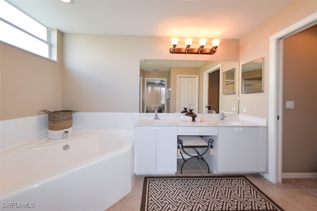 bathroom featuring vanity, tile patterned floors, and a bathing tub